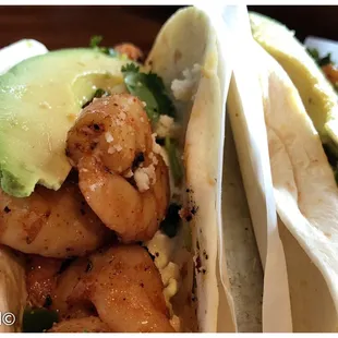 Set of three spicy and tangy shrimp tacos.