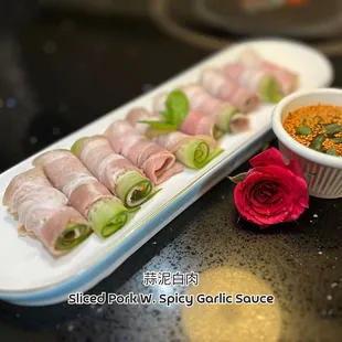 a plate of food and a bowl of sauce