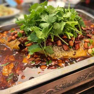 a dish of fish with beans and herbs