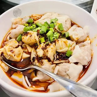 a bowl of soup with dumplings