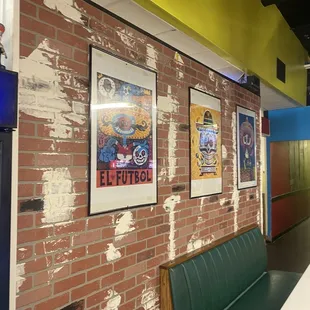 a brick wall with posters on it