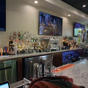 a bar with a lot of bottles of alcohol