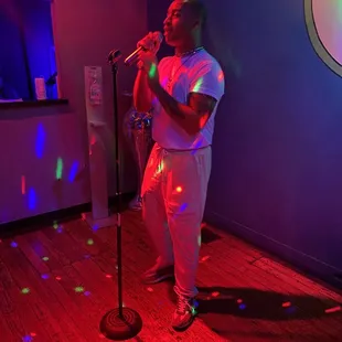 a man singing into a microphone