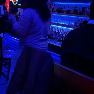 a woman sitting at a bar