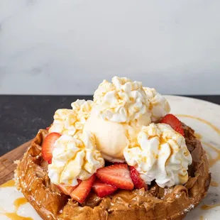  a waffle topped with ice cream and strawberries