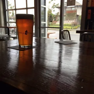 a pint of beer on a wooden table