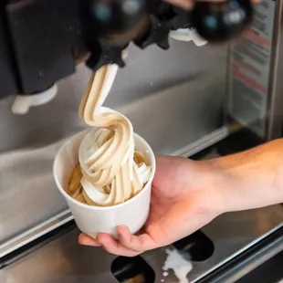 a person holding a cup of noodles