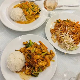 two plates of food and a glass of wine