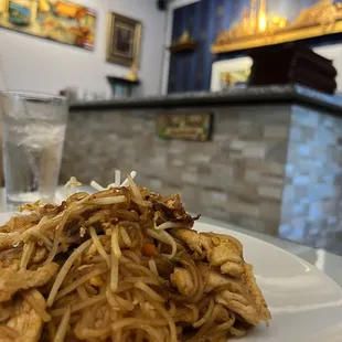 a plate of noodles and a glass of water