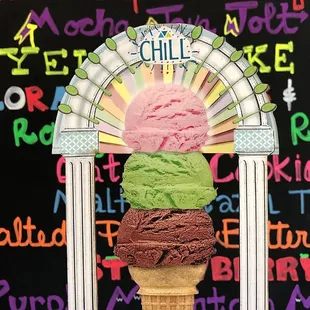 three scoops of ice cream in a cone