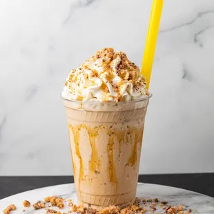  a milkshake topped with whipped cream and caramel