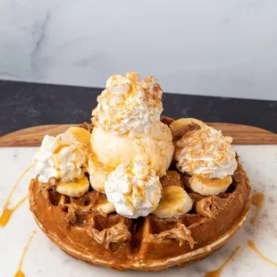  a waffle topped with bananas and ice cream