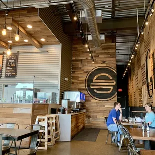 two people sitting at tables in a restaurant
