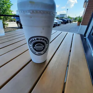 a cup of iced coffee on a wooden table