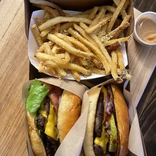 Parm Garlic fries, 8oz Elvis burger (left), 4oz basic cheeseburger (right), extra peanut butter sauce on the side. Carry out order.