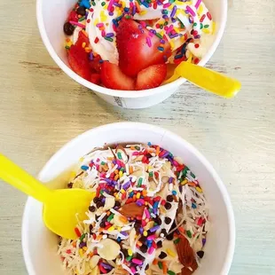  two bowls of ice cream with sprinkles and strawberries