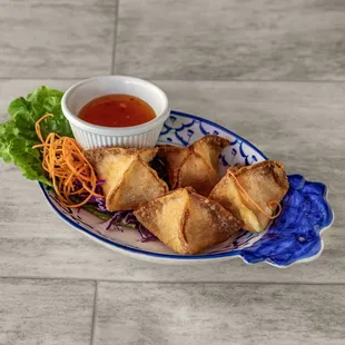 a plate of food with dipping sauce