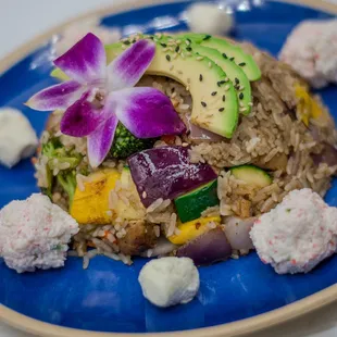 Savory fried rice with Squash, Red onion flavorful shrimp teriyaki, chicken and steak, creamy cream cheese, and fresh avocado. Topped with T