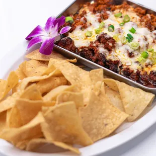 Melted mozzarella with pork chorizo served with a side of crispy chips. Savory, gooey, and satisfying.