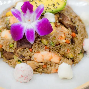 Savory fried rice with Squash, Red onion, flavorful shrimp teriyaki, creamy cream cheese, and fresh avocado. Topped with Tampico. Served wit