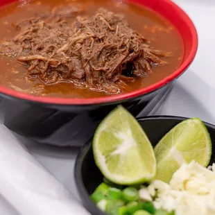 Tender birria served with flavorful consome and 4 warm corn tortillas for a satisfying meal. Enjoy the hearty and savory flavors in each bit