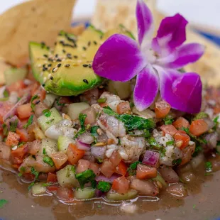 Bright and zesty shrimp marinated in tangy lime juice, mixed with refreshing cucumber, red onion, tomato, and creamy avocado. Topped with ci