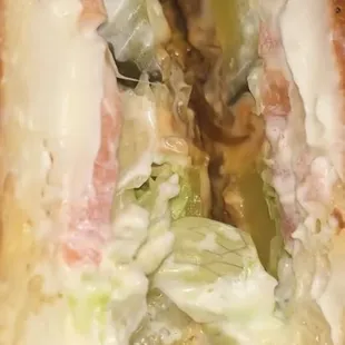 ows a hot dog with lettuce and onions