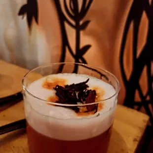 a drink in a glass on a table