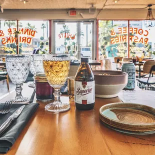 a table with a glass of wine and a bottle of wine