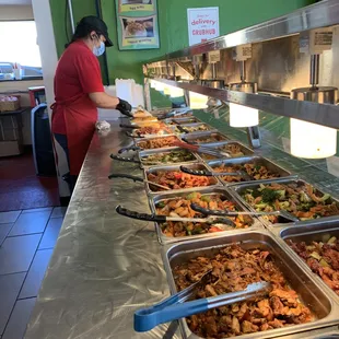 a line of food being served at a restaurant