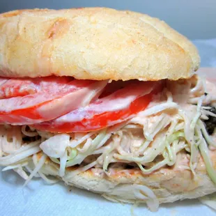 Chimichurri perfection!  Tomato, crunchy cabbage in secret sauce, oregano beef patty.  All in between a fluffy Pan de Agua bun.