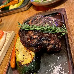 12 oz Ribeye with grilled zucchini and yellow squash.