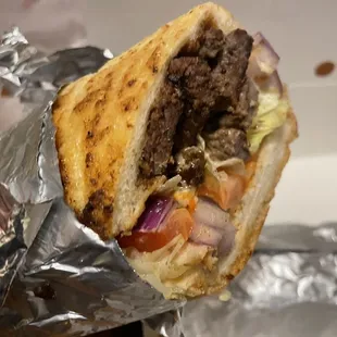 a hamburger wrapped in foil