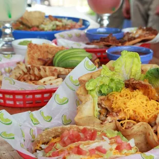 a table full of tacos and drinks