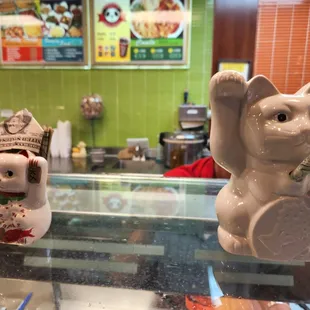 two figurines of a cat and a mouse