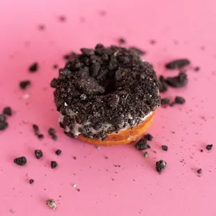 a donut on a pink surface