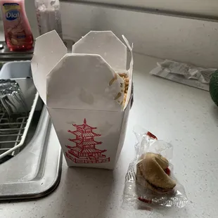 a hot dog in a paper bag on a kitchen counter