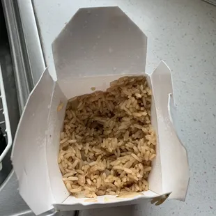 rice in a paper container on a counter