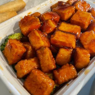 tofu and broccoli in a plastic container