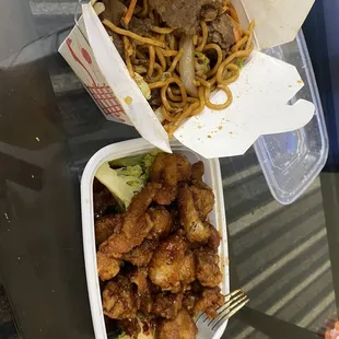 two take out containers of food on a table
