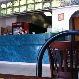 a woman sitting at a restaurant counter