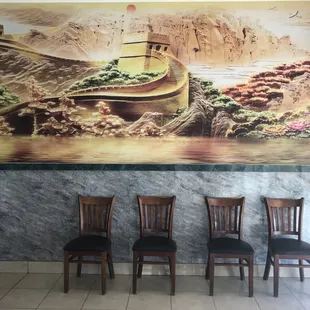 three chairs in front of a painting