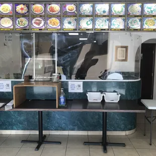 a restaurant counter with a lot of food on it