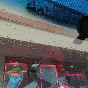 a view of a storefront through a car window
