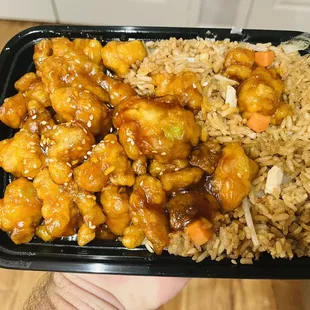 a hand holding a container of food