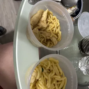 three bowls of noodles and a sandwich on a table