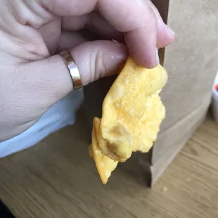 a hand holding a piece of food