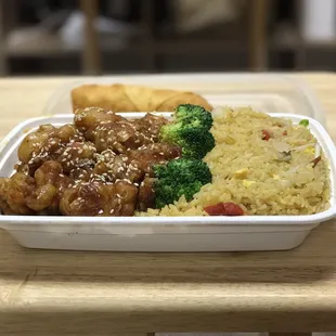 Sesame chicken combination to go. Comes in a plastic container with pork fried rice and an egg roll on the side.