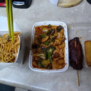 two take out containers of food on a table