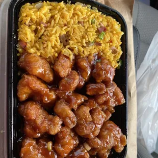 a tray of chicken and rice